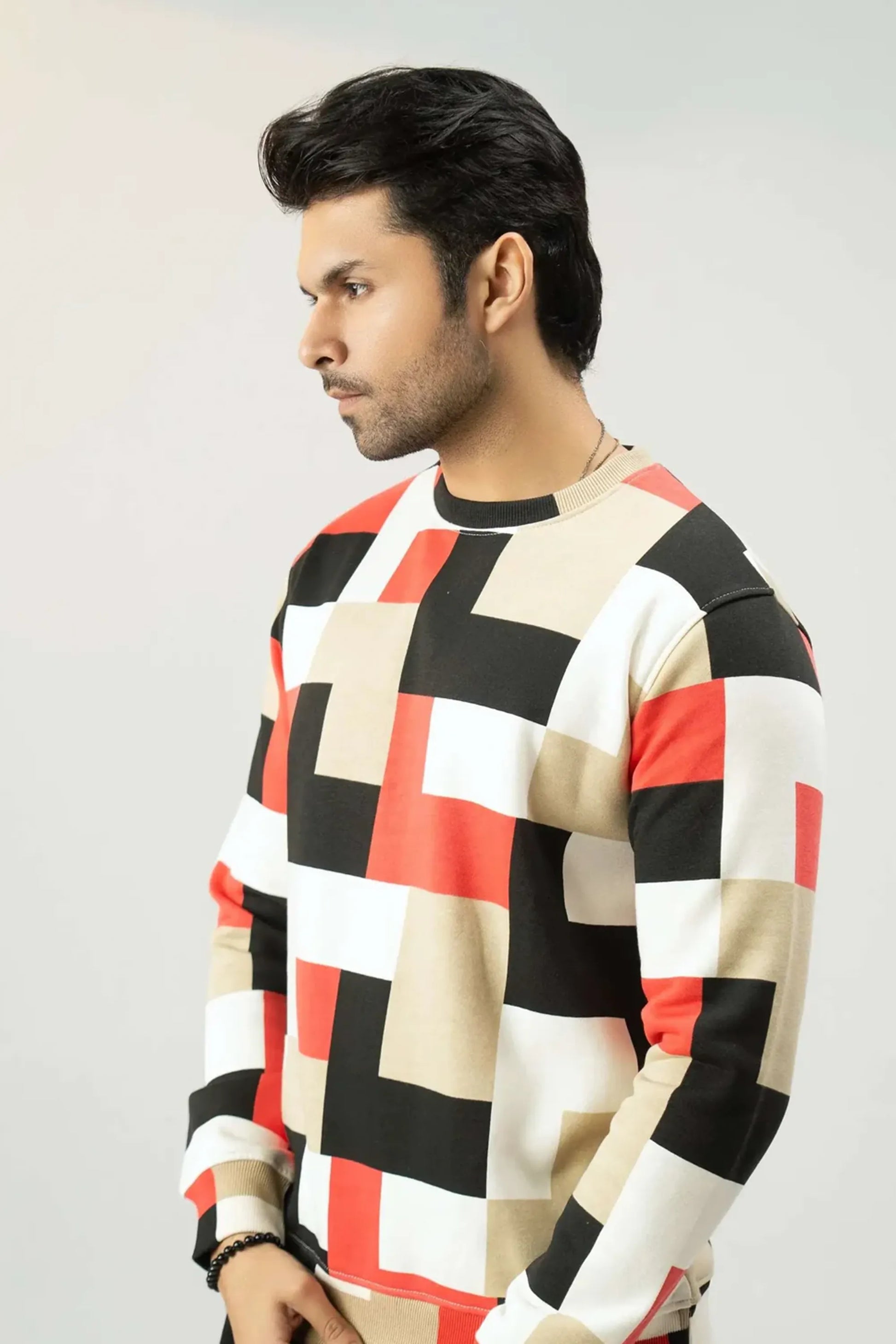 Side angle view highlighting the fit of the checkered sweatshirt