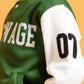 Side detail of green varsity jacket sleeve with number patch