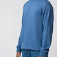 Side profile view showing fit of navy turtle neck sweater