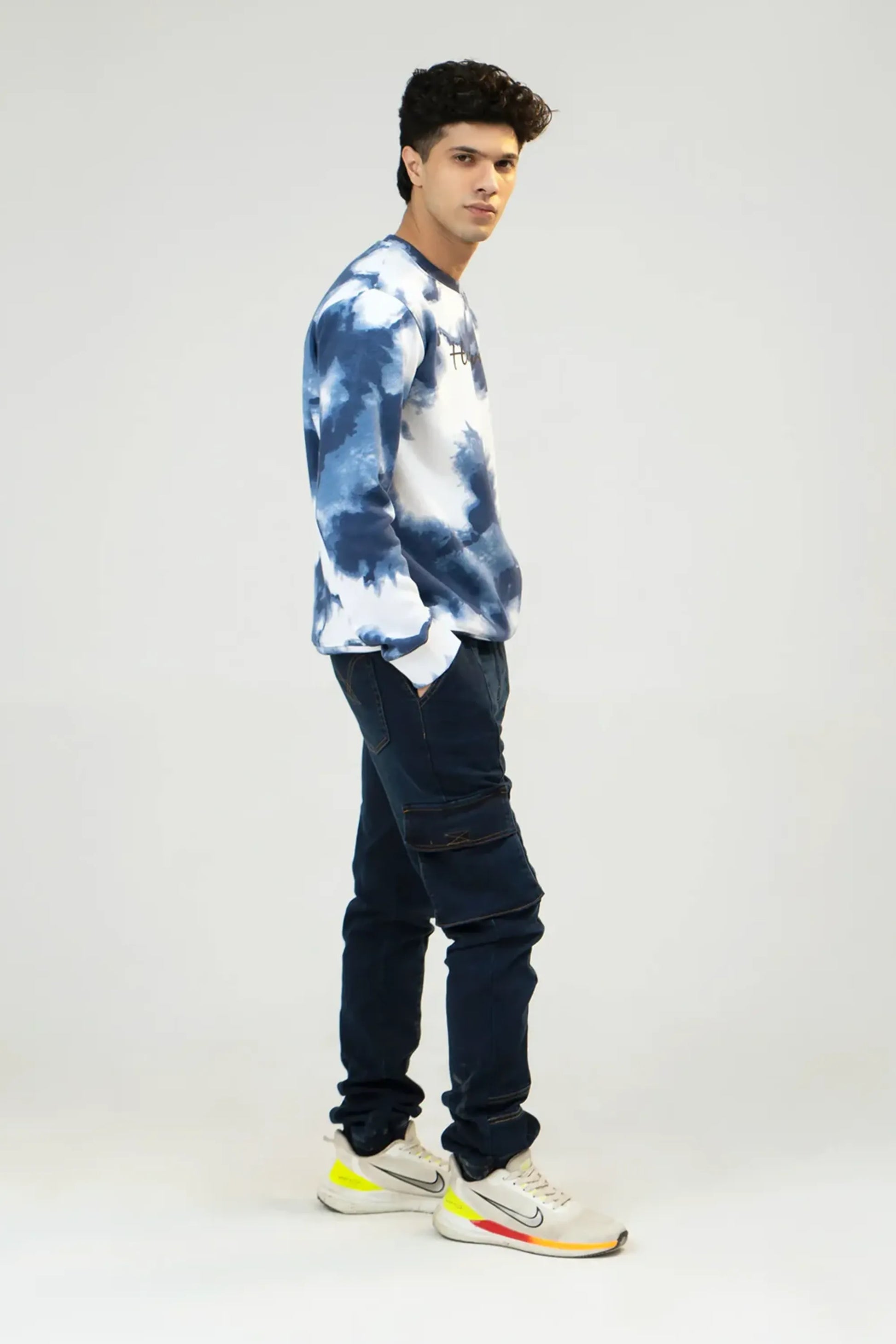 Side profile, full-length view showing the fit of the tie-dye camouflage sweatshirt