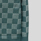 Sleeve-side detail displaying a checkered pattern on a blue wool cardigan