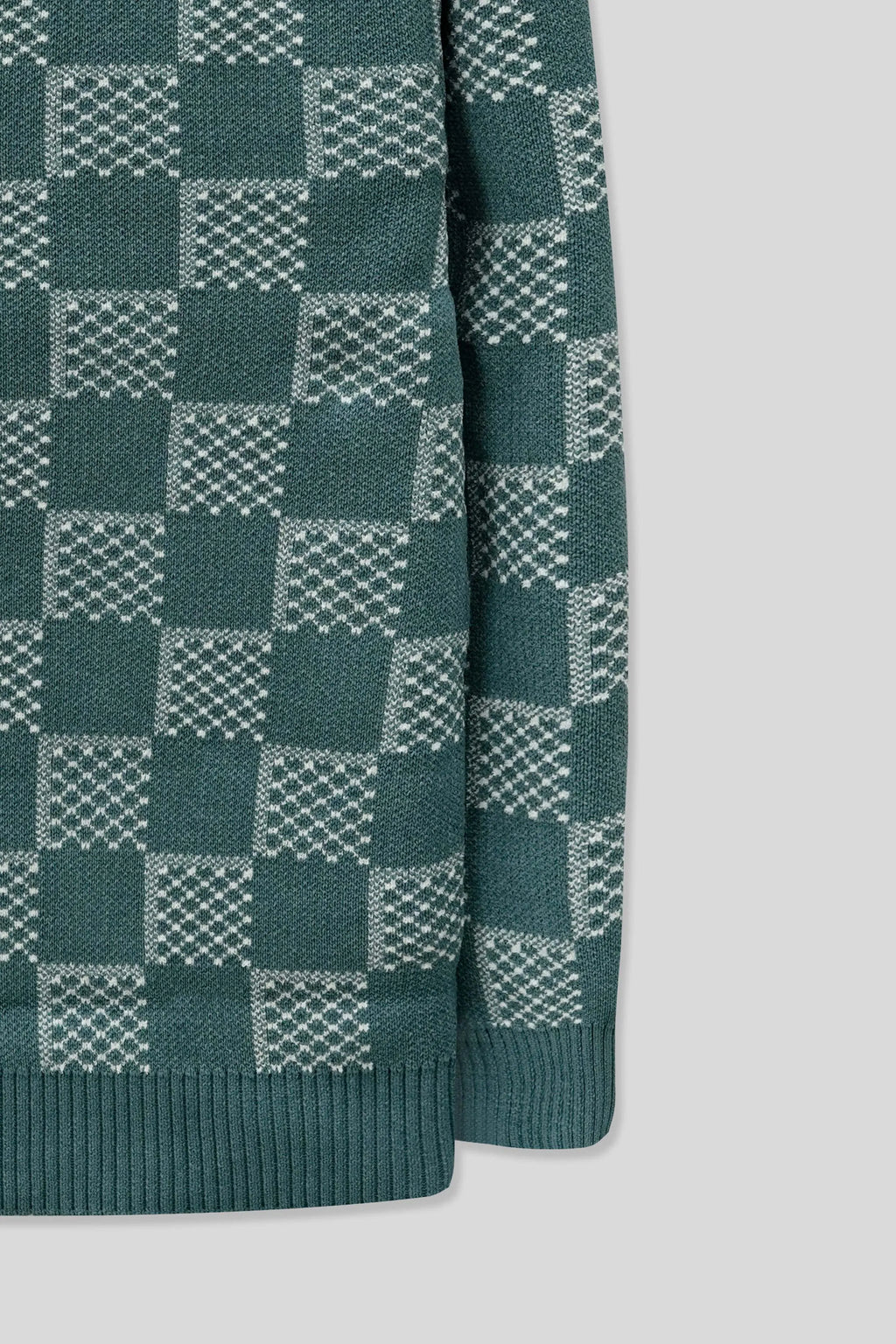 Sleeve-side detail displaying a checkered pattern on a blue wool cardigan