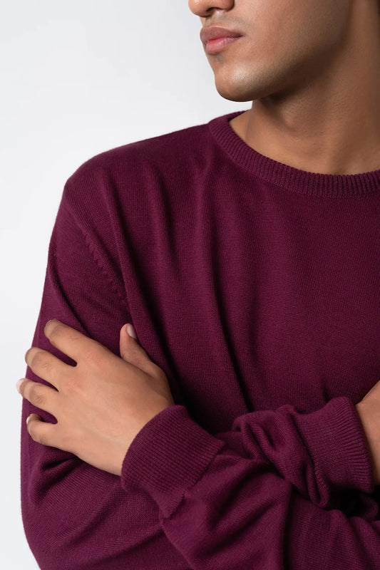 Sleeve and arm close-up highlighting fabric of crew neck sweater maroon