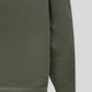Sleeve and side detail showing the smooth finish of the olive knit cardigan
