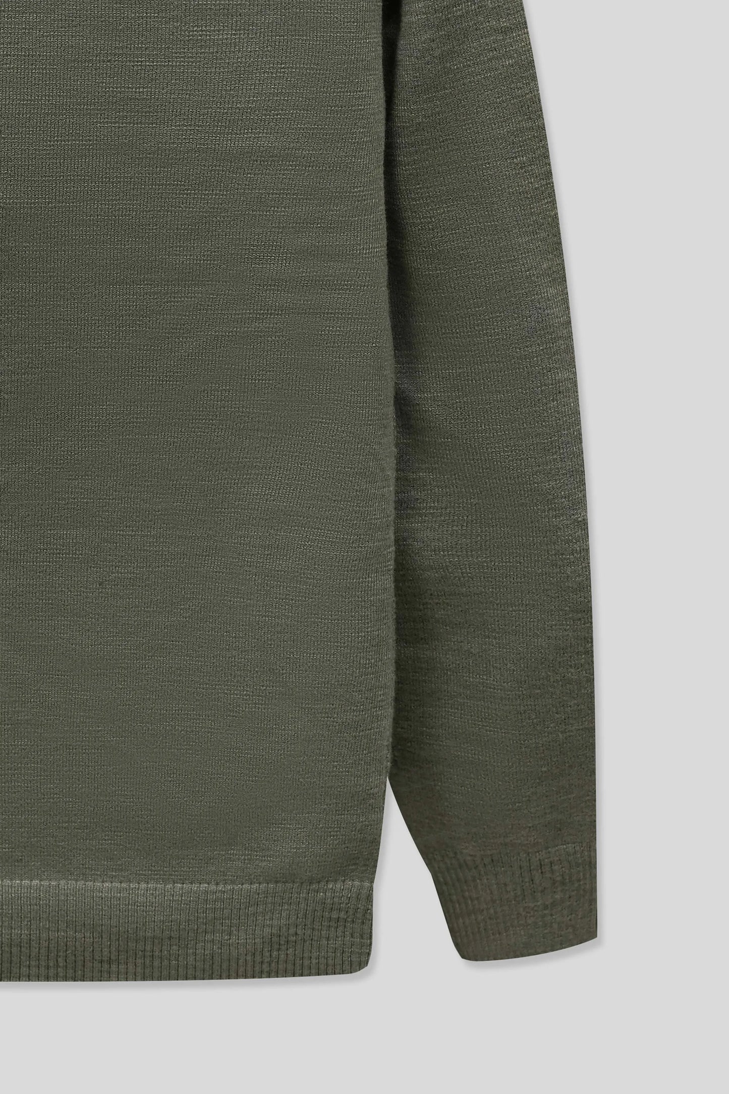 Sleeve and side detail showing the smooth finish of the olive knit cardigan
