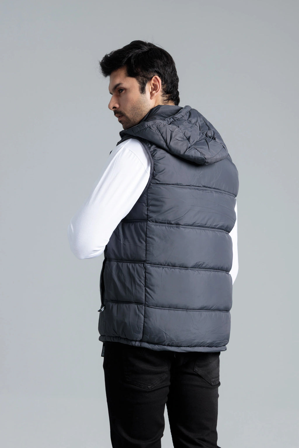 Back view of man wearing sleeveless grey parachute jacket