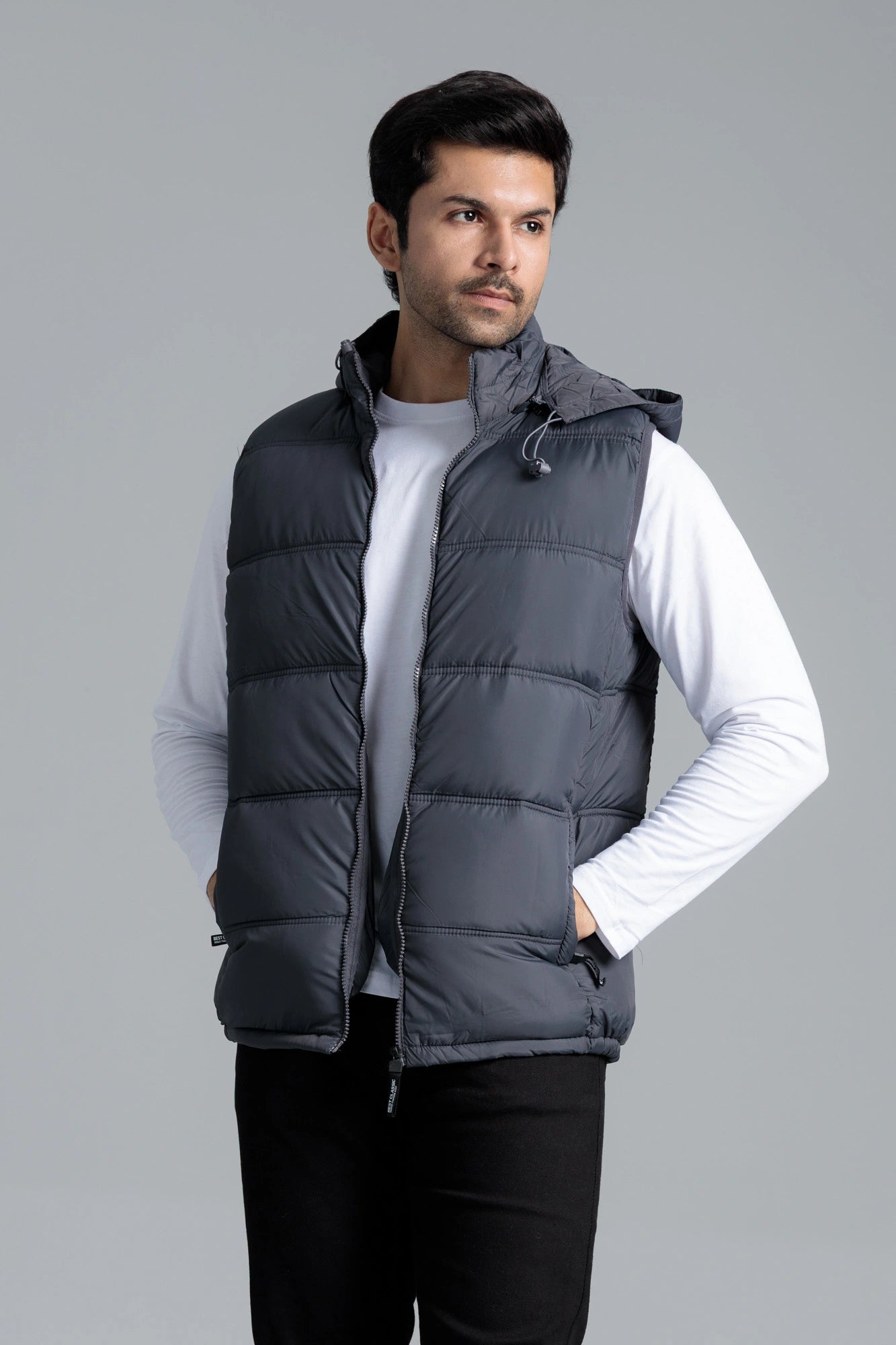Man wearing sleeveless grey parachute jacket front view