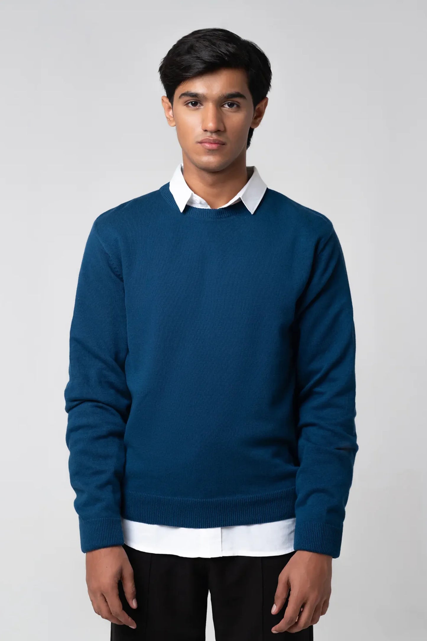Straight full body view in navy crew neck sweater