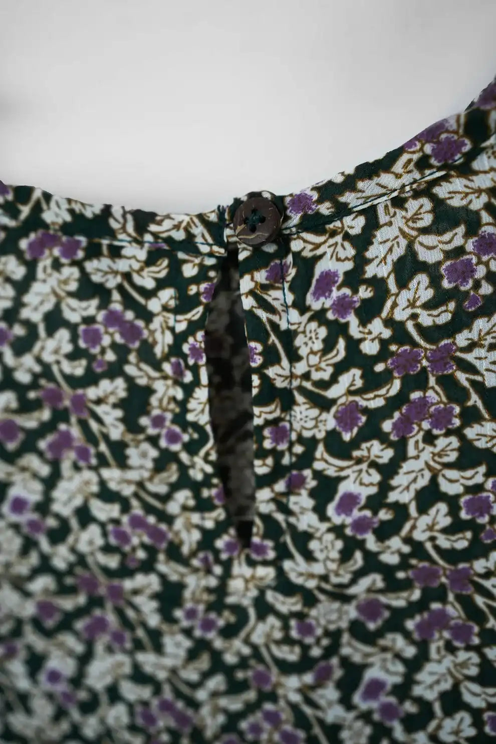 Floral-patterned fabric with a focus on a black and white striped tie