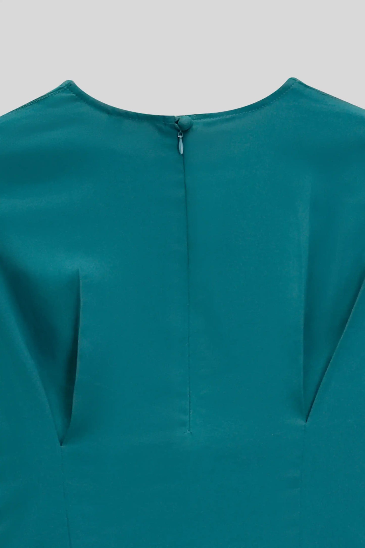 Teal dress with a close-up of the neckline