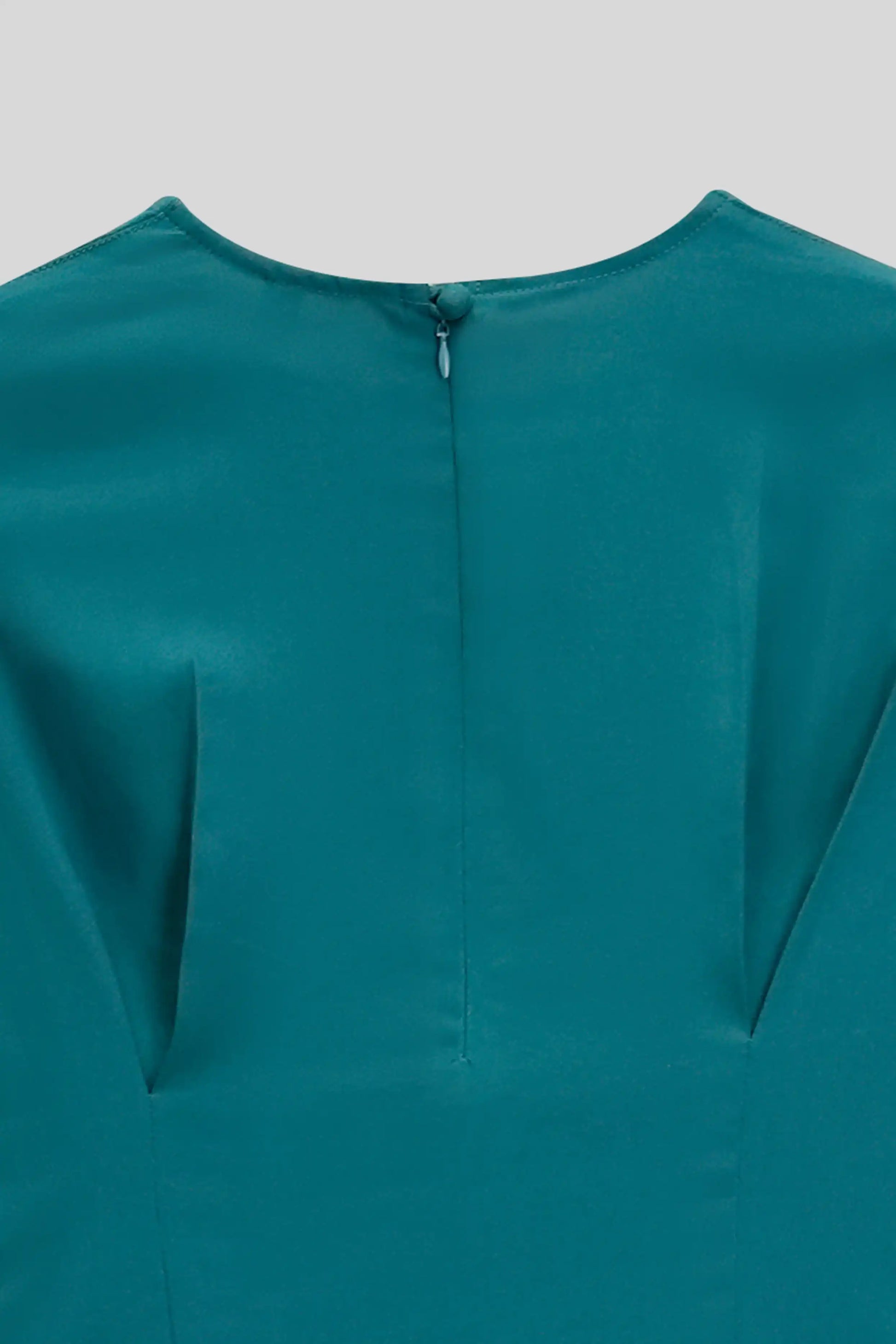 Teal dress with a close-up of the neckline