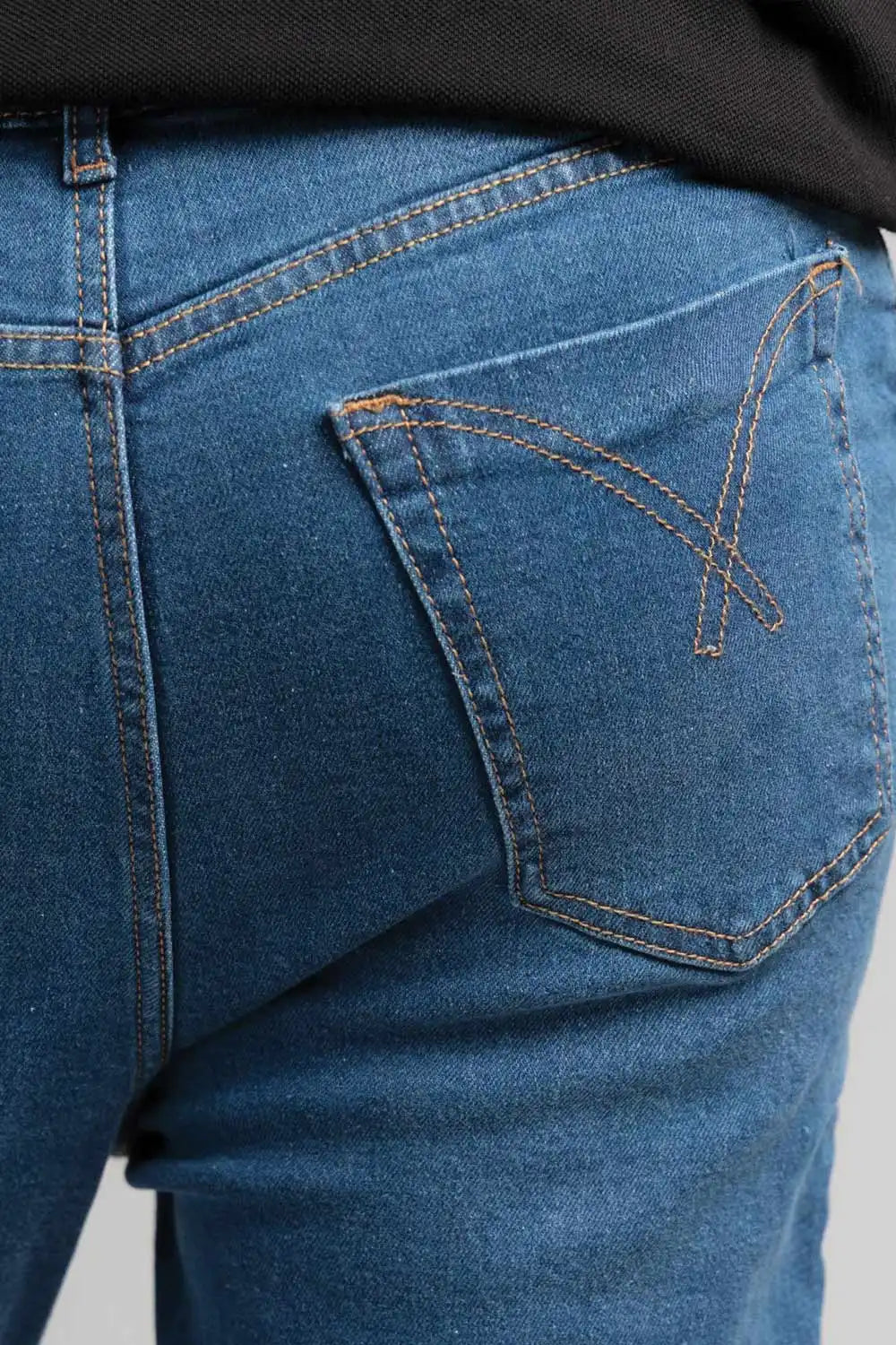 Close-up of blue jeans with a focus on the pocket area