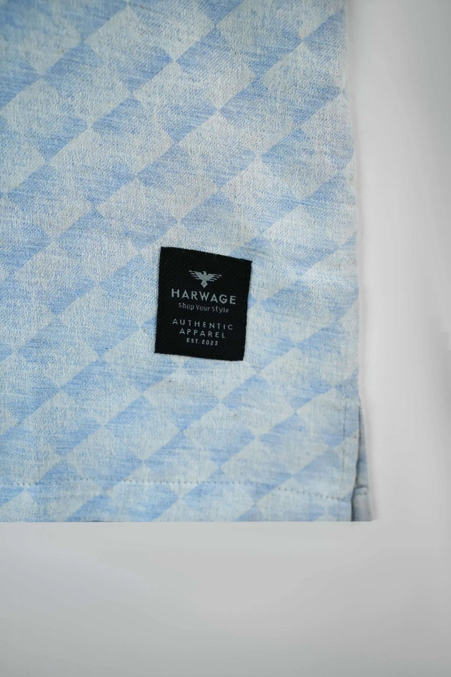Textured light blue cotton shirt fabric with Harwage label