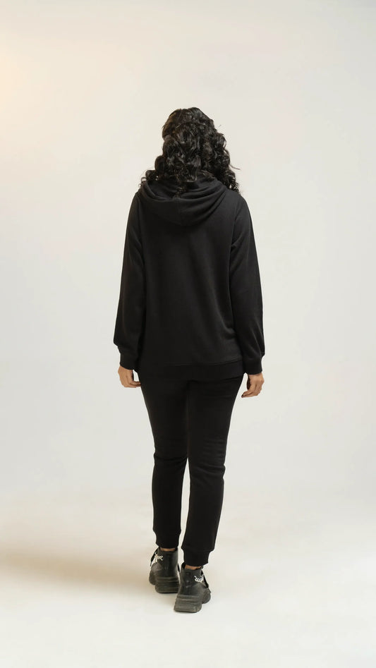 View of women’s black regular tracksuit from back side 