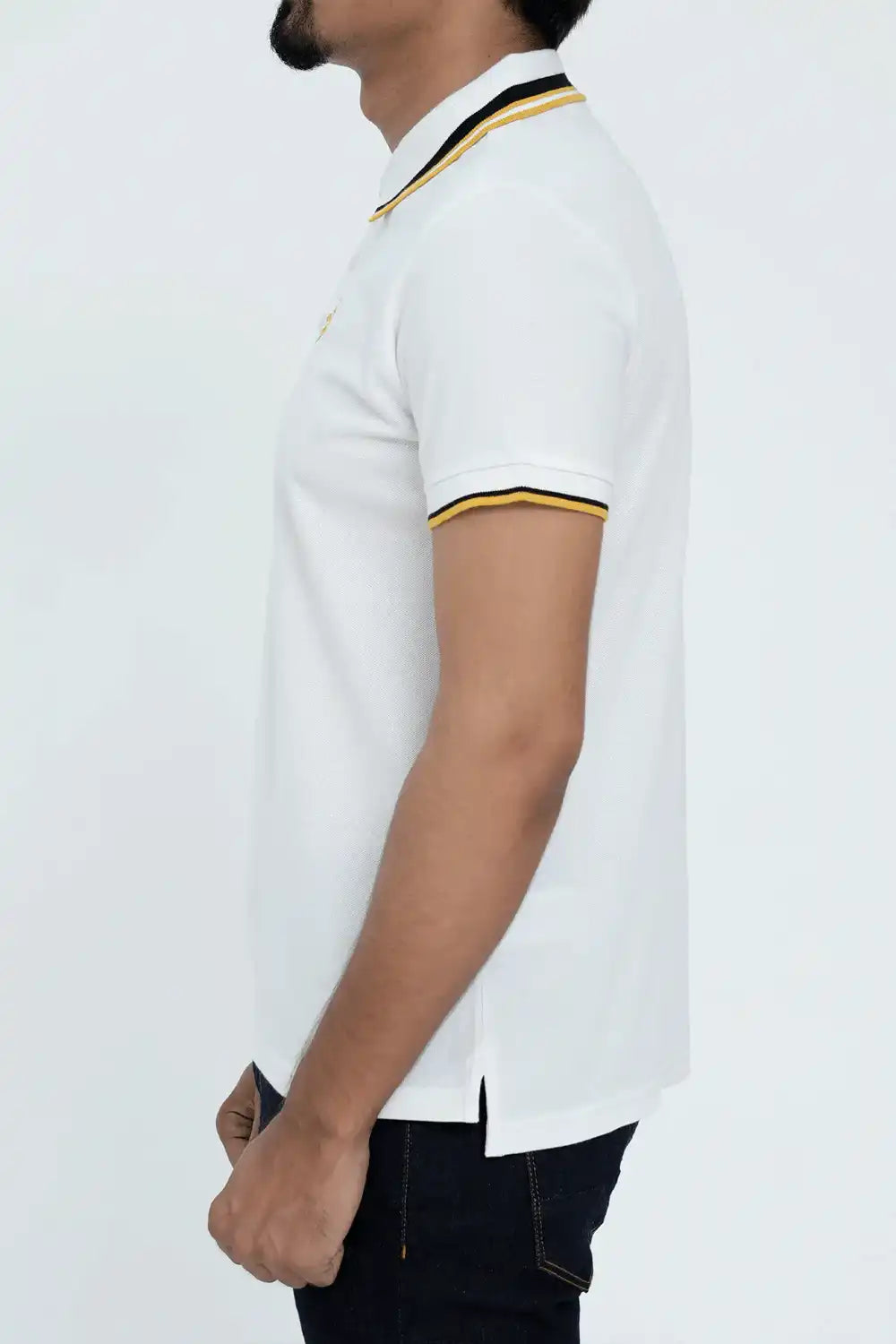 A white polo shirt with black and gold trim worn by a person