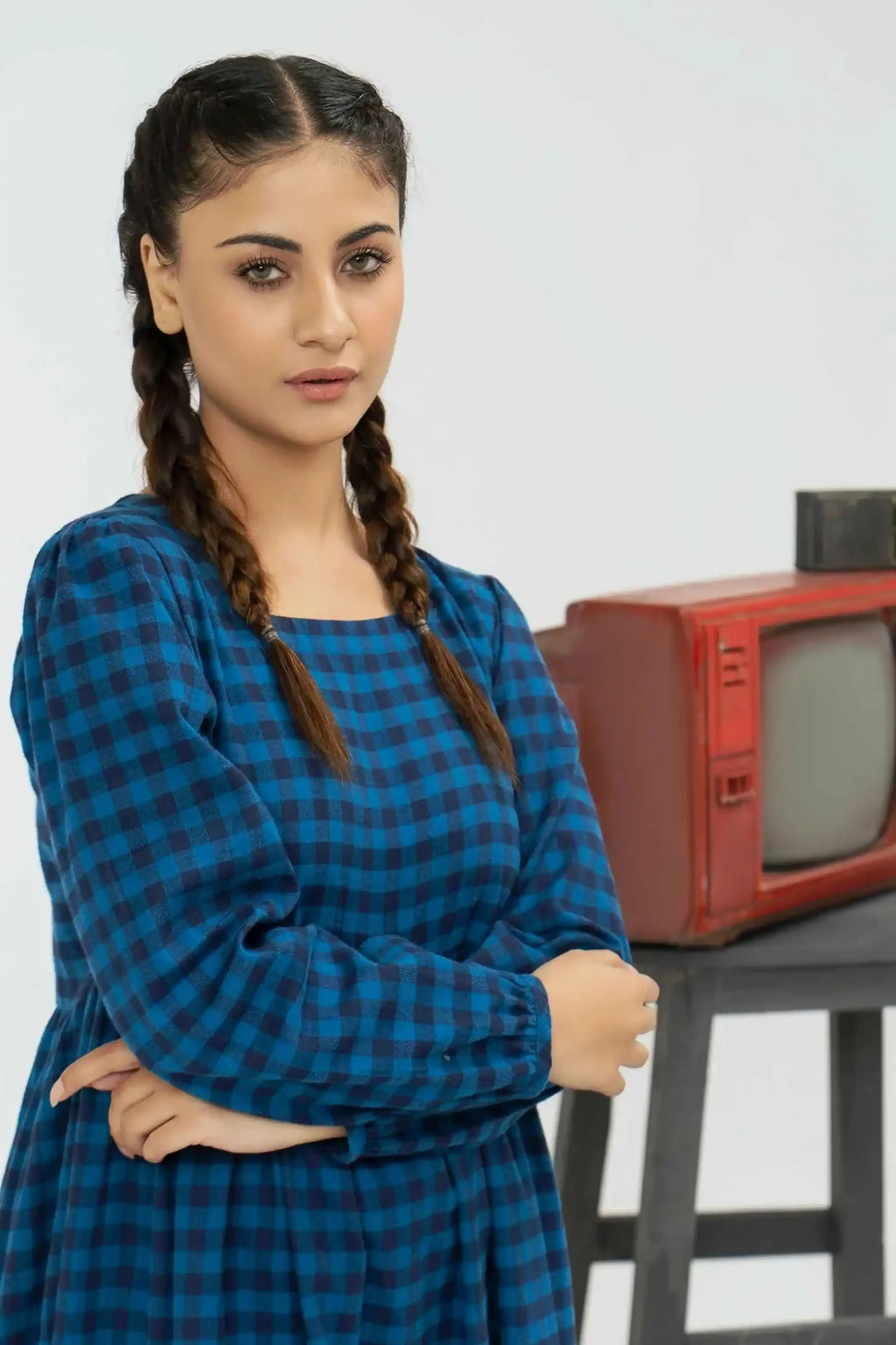 Woman in a blue checkered dress
