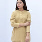 Woman wearing a beige kurta with a plain background