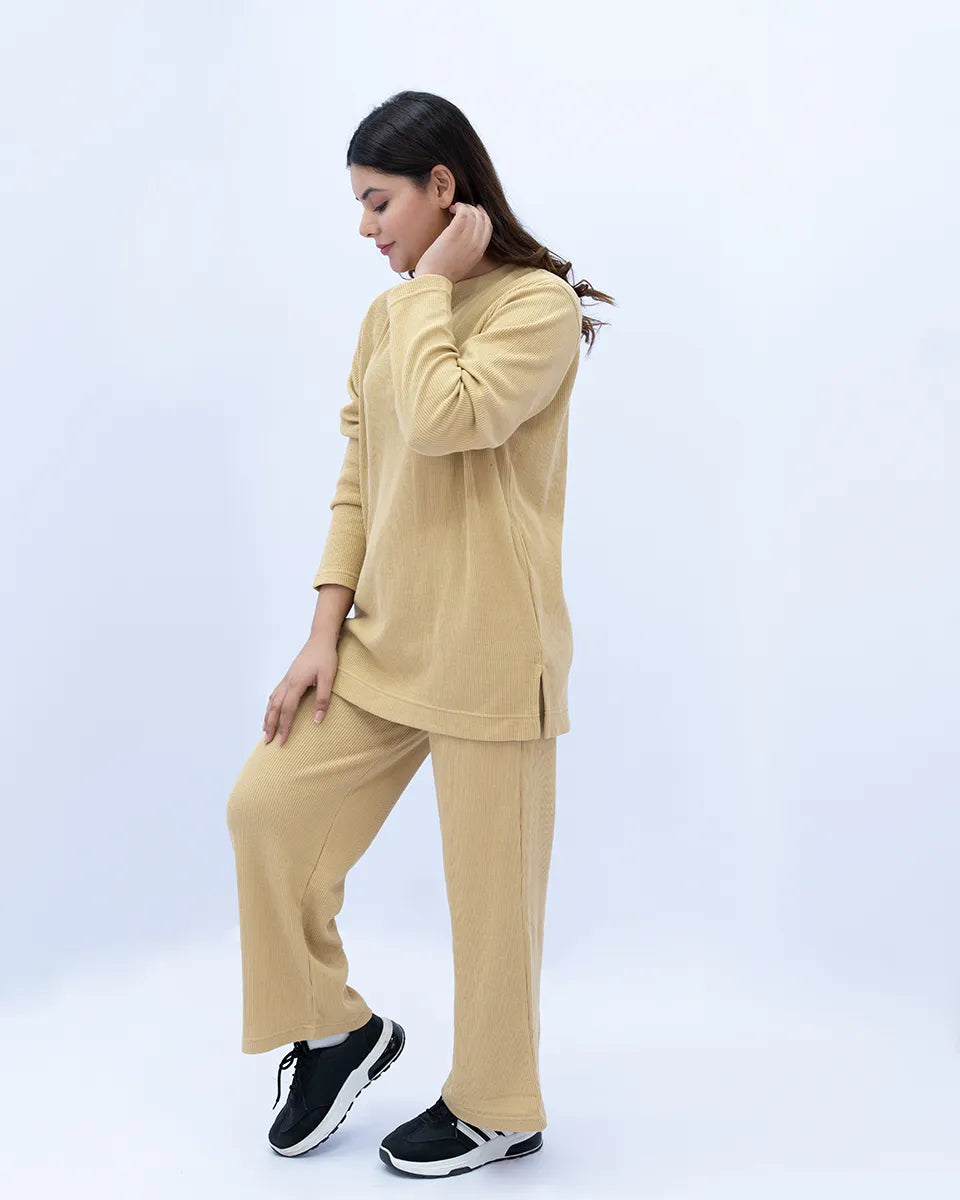 Woman wearing a beige outfit on a white background