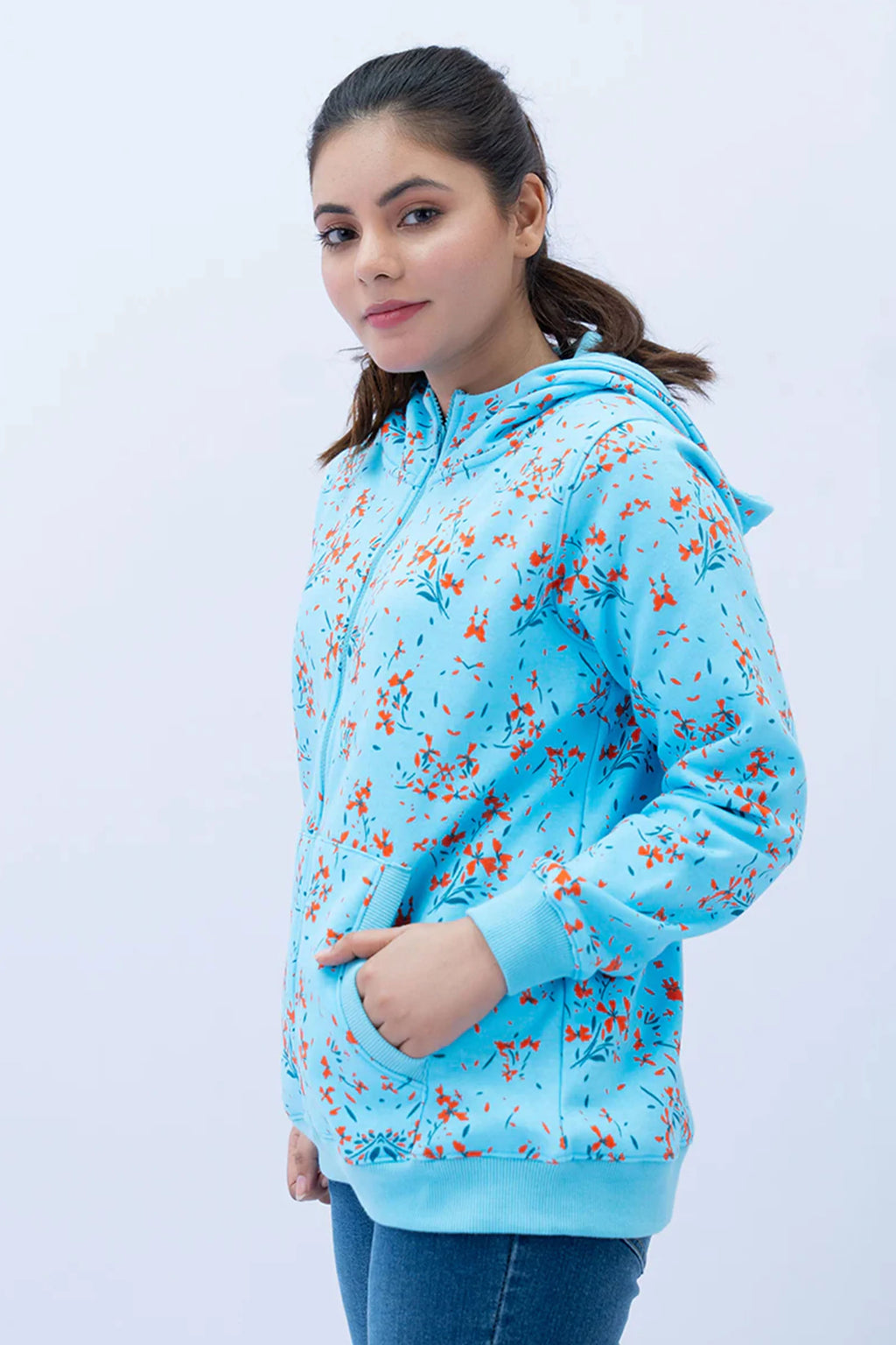Woman wearing a blue floral hoodie against a white background