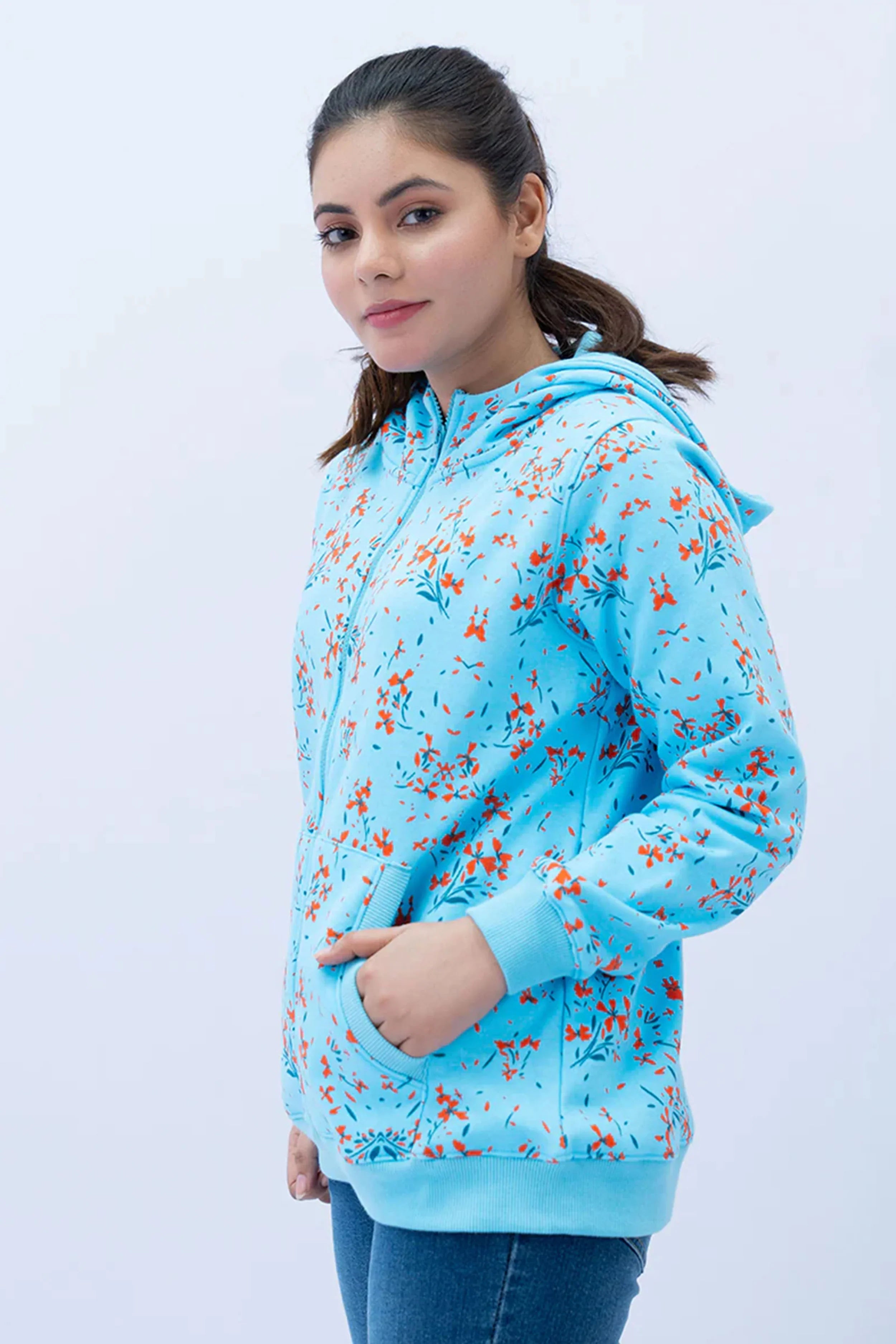 Woman wearing a blue floral hoodie against a white background