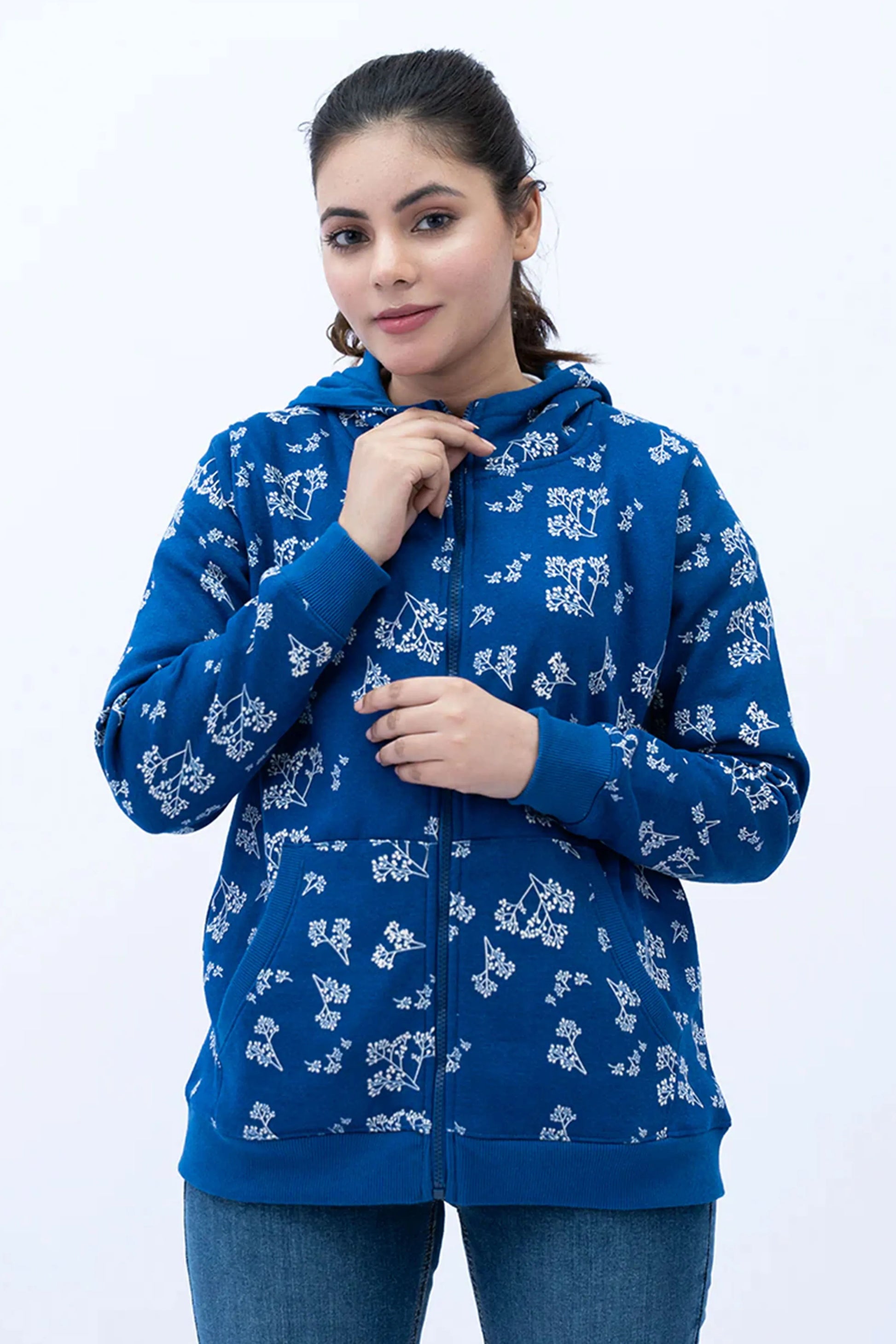 Woman wearing a Classic Blue Zipper Hoodie with white floral patterns
