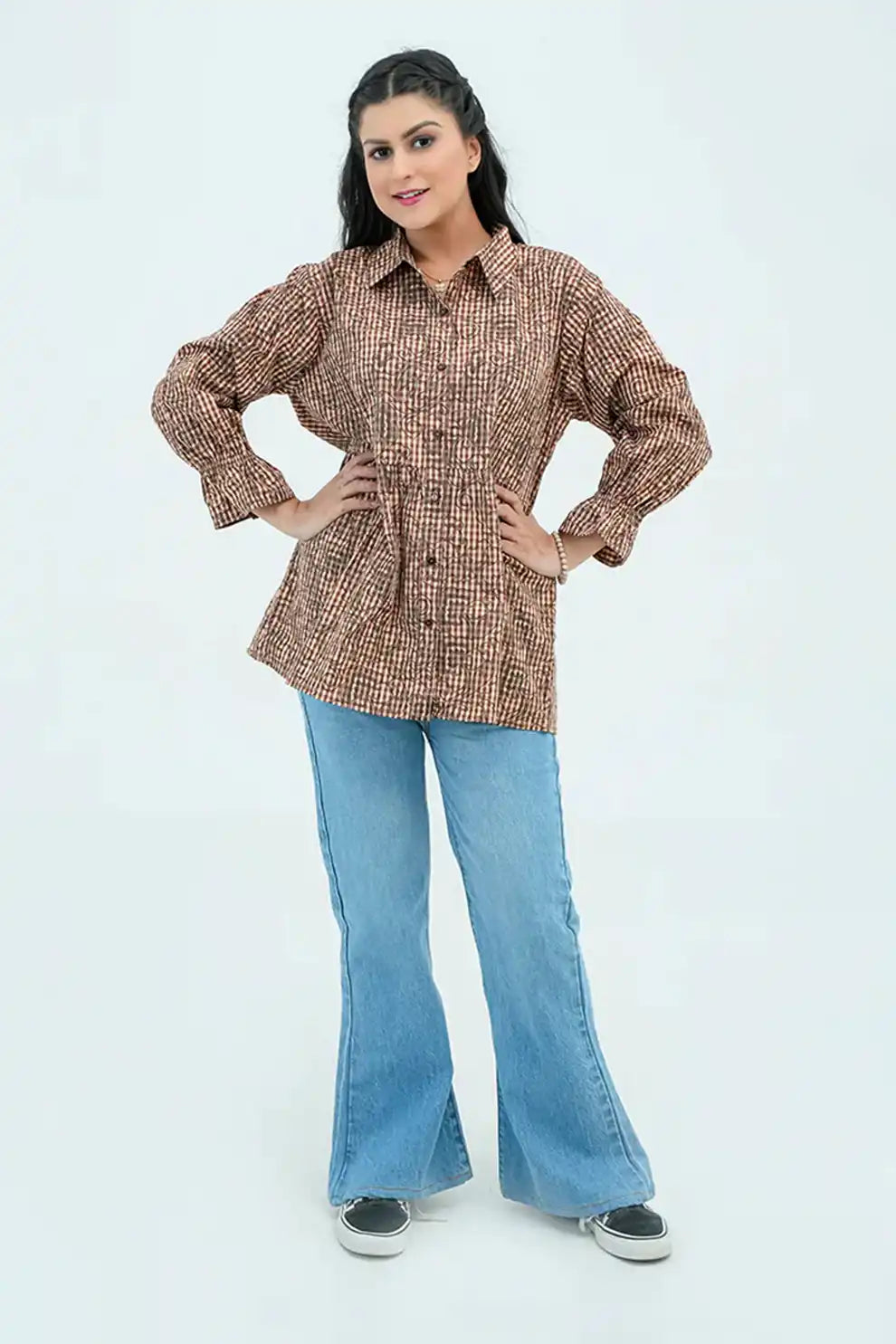 Woman wearing a brown patterned shirt 