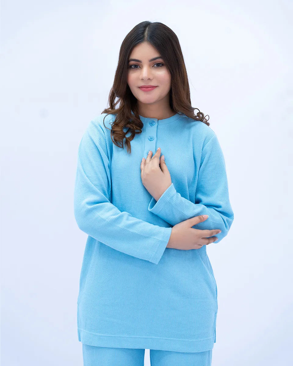 Woman wearing a light blue outfit on a white background