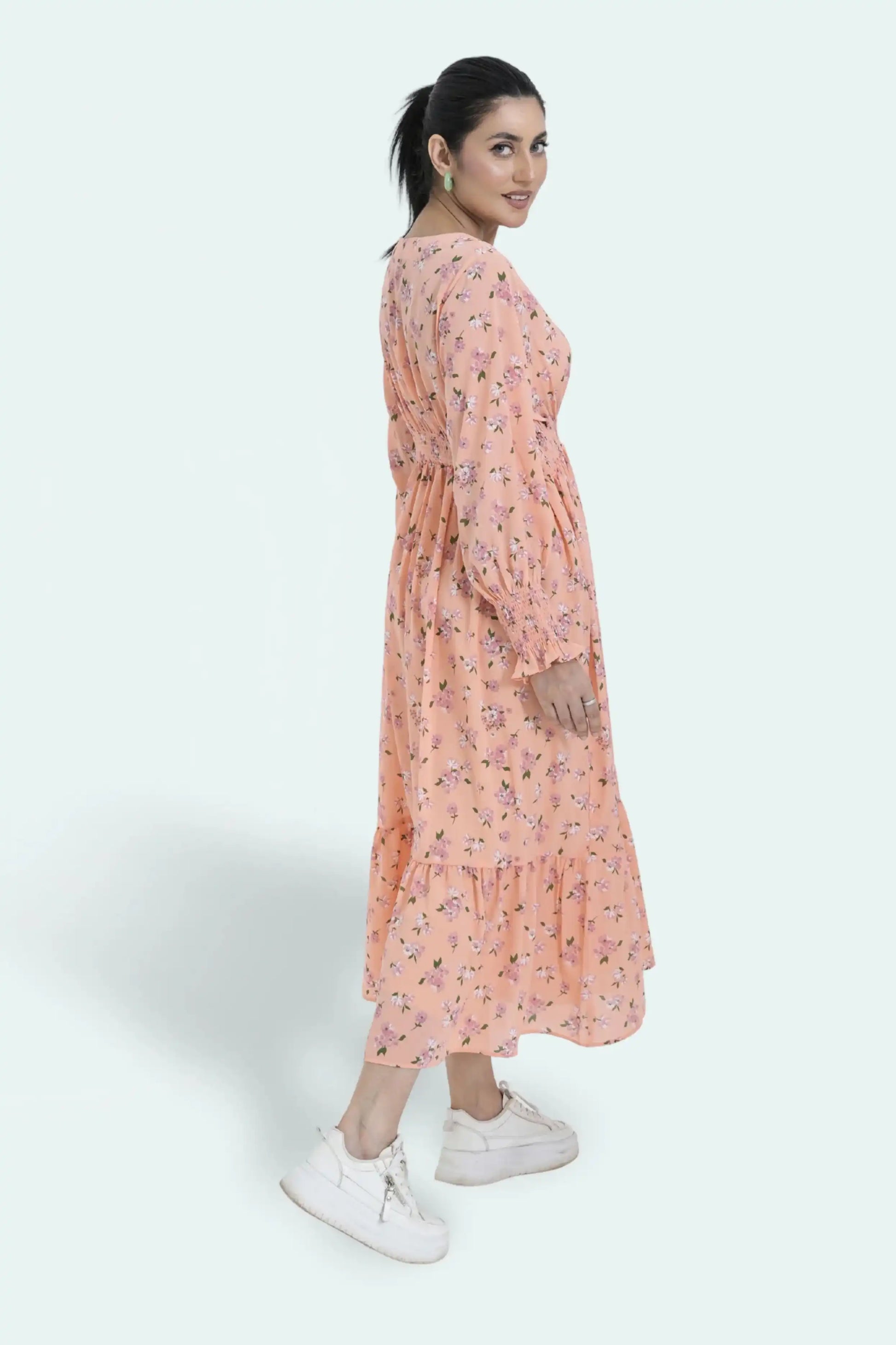 Woman wearing a peach floral dress