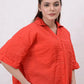 Woman wearing a red textured shirt against a white background