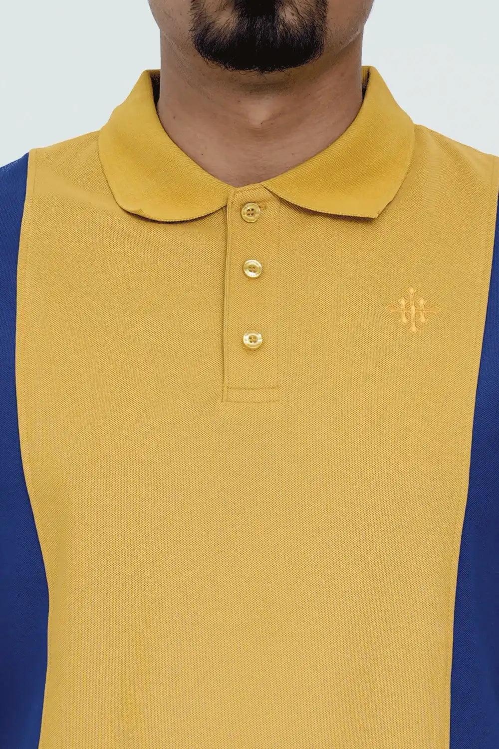 Yellow polo shirt with a brand logo worn by a person 