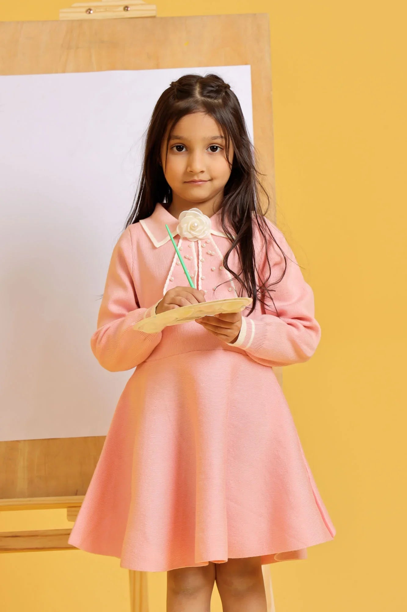 Young girl in a pink dress, posing gracefully