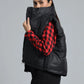 Black puffer vest over a red and black checkered shirt